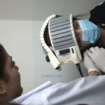 female doctor performing laser therapy